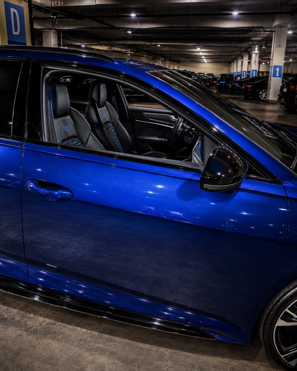 Polished blue performance vehicle with a spotless interior