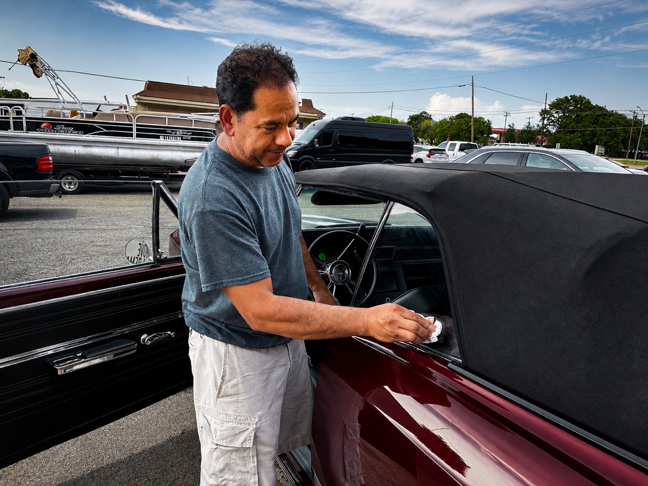 An Adaptive Detailing professional carefully finishing a classic car